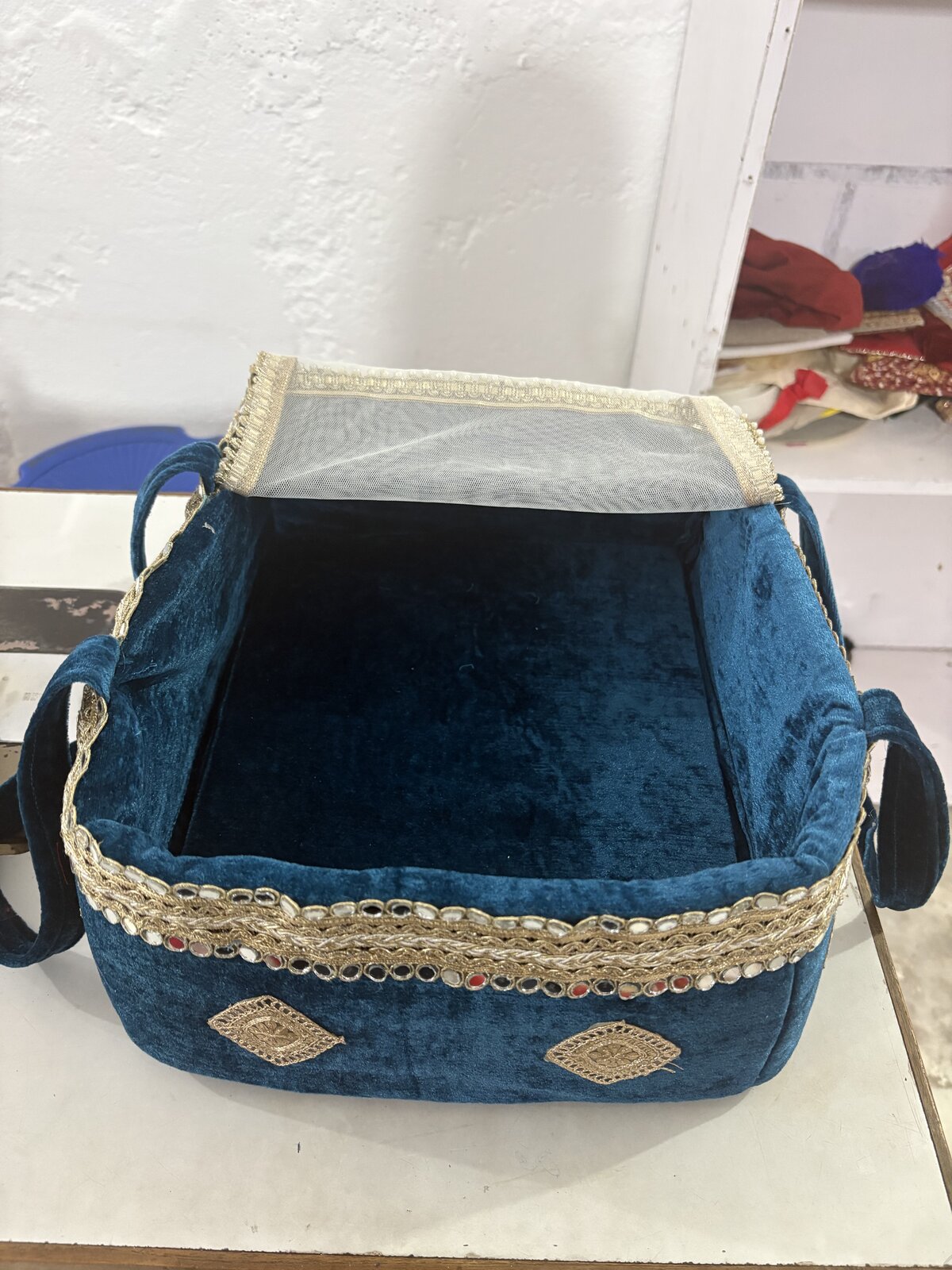 Laddu Gopal in Royal Red basket — devotional display